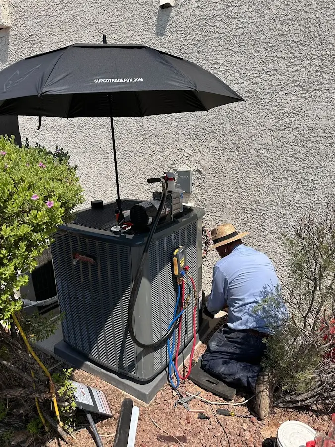 HVAC technician performing outdoor AC maintenance in Orcutt