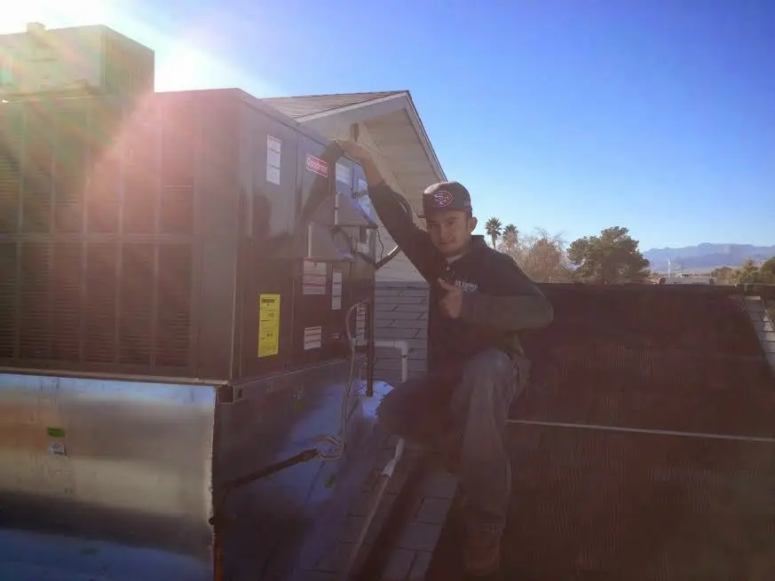 HVAC technician performing Boiler Repair on a rooftop unit in Orcutt